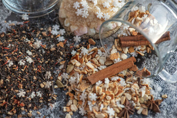 top view on heap of winter hot drink ingredient spilled on table with stick of cinnamon  and sugar star shape