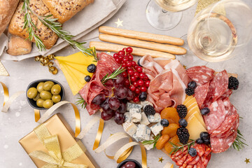 Party charcuterie board italian food antipasti prosciutto ham, salami and cheese appetizers served in the shape of a Christmas tree. party food for New Year's Eve, Christmas or birthday