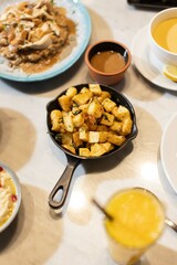 A skillet of crispy batata harra (spicy Lebanese potatoes) sautéed with garlic and garnished with fresh parsley, offering a flavorful and authentic Middle Eastern side dish.