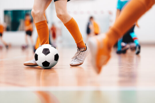 Fototapeta Indoor soccer sports hall. Football futsal player, ball, futsal floor. Sports background. Youth futsal league. Indoor football players with classic soccer ball.