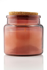 Scented candle in glass jar isolated on white background