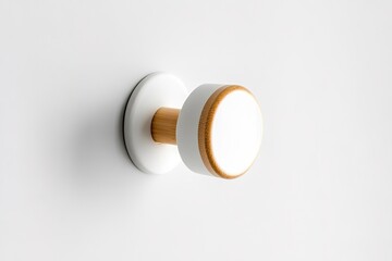 Minimalist white knob with wooden accent on clean surface