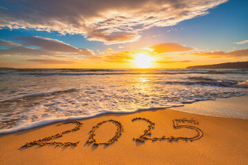 Happy New Year 2025 concept, lettering on the beach. Written text on the sea beach at sunrise.