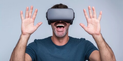 Naklejka premium Excited man enjoying virtual reality with hands raised and smiling.