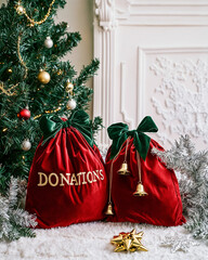 Velvet donation bags with gold lettering and festive accents under a Christmas tree, ideal for...