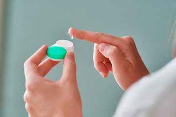 Young woman using soft contact lenses instead of glasses for vision correction