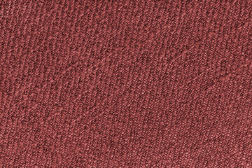 Red Jacquard fabric with diagonal woven, coarse weave texture upholstery cloth. Textile background, furniture textile material, wallpaper, backdrop. Cloth structure close up, macro.