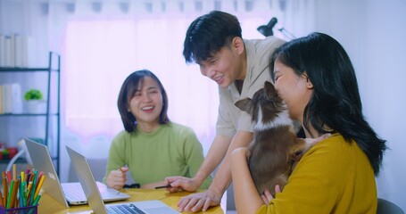 Young professionals Creative Team Collaborating working together discussing ideas in a bright Modern Office with Laptop and Cute Dog for Innovative Design Project