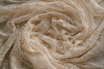 Abstract neutral background, crumpled draped elegant folds of openwork lace cloth, sun light with soft shadows, aesthetic sustainable bohemian backdrop, copy space