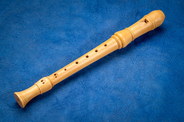 wooden recorder flute instrument, classic German style, against art paper