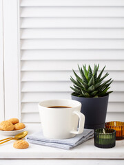 Black coffee in mug with on marble cutting board. White background. Copy space.