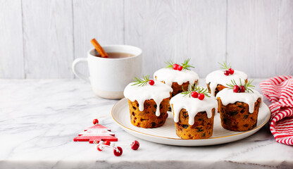 Christmas pudding, cakes with tea. Traditional dessert. Marble table. Grey background. Close up. Copy space.