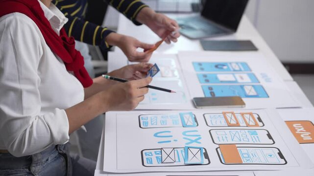 Designers collaborating on user experience for an application, focusing on innovative solutions and effective strategies