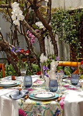 sophisticated and colorful table setting for lunch in the garden