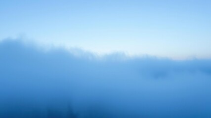 Fototapeta premium Ethereal soft blue mist hovering above a serene landscape, atmospheric, peaceful, serene