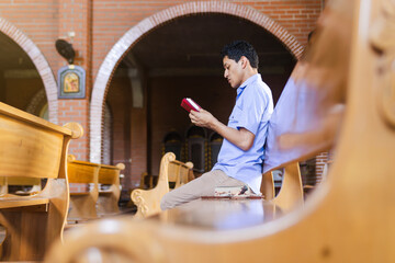 Christian man sitting, praying, and reflecting while reading the Holy Bible, seeking theological and religious knowledge