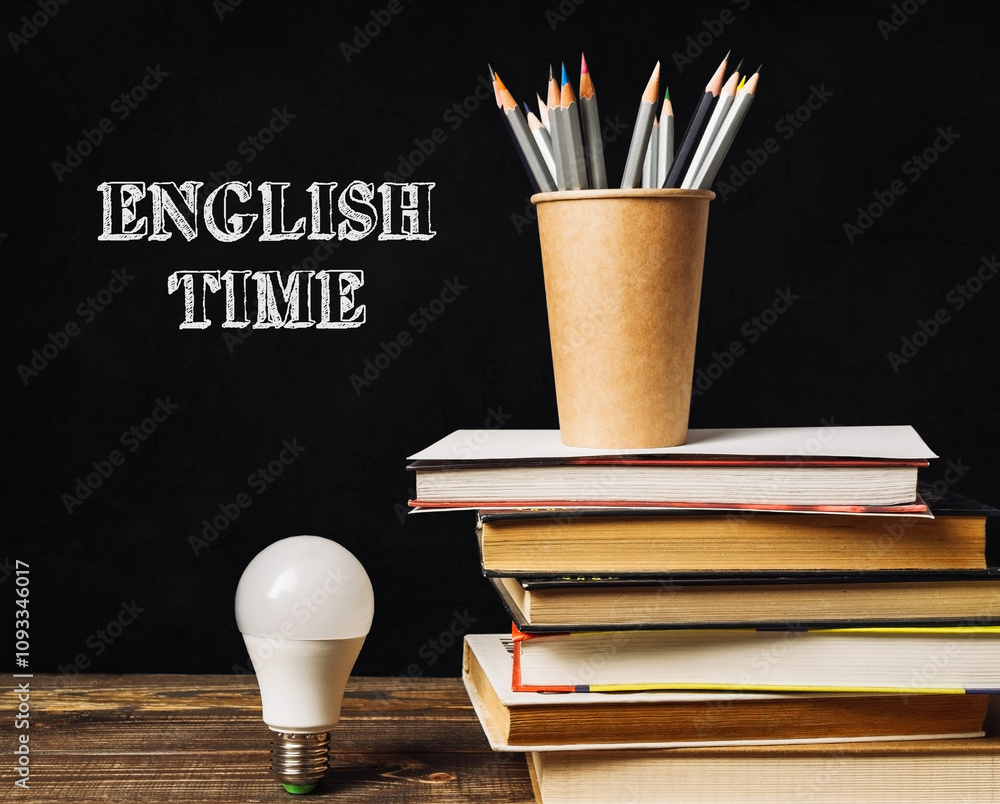 Aufkleber a stack of books and a light bulb on a table with the words english time written on the table