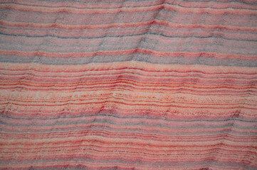 Beautiful natural striped texture, cut stone, red-orange-yellow-brown-blue-green background.