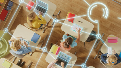 Top View: Children in a School Use Tablets and Laptops to Study Digital Literacy, AI Data Lines...