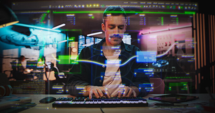 Portrait of Male Coder Working on Holographic Screen that Shows Coding and Programming Lines. Transparent Screen Show Software Programming Interfaces. Entrepreneur Working on a Video Game, App, Ideas