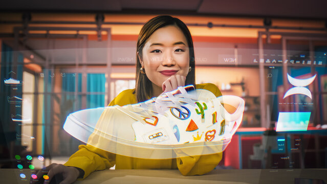 Asian Female Designer Uses a VFX Hologram Screen to Create a 3D Shoe Design in Graphical Interface Software. Young Professional Entrepreneur doing Digital Fashion, Sneaker, and Clothing Design
