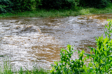 River with dirty water, flood in Austria.