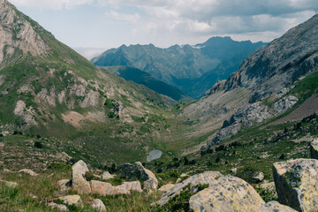 Naklejka premium A breathtaking view of lush green hills unfolds, capturing the serenity of the French Pyrenees
