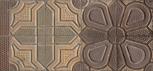 Colorful sidewalk tiles with geometric shapes in an urban environment. View of colorful sidewalk tiles with geometric design. Background of beautiful street tiles close-up