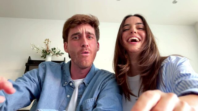 A close perspective of a couple holding a smartphone in their hands as they browse through humorous online content, scrolling with ease while smiling and sharing a lighthearted and joyful interaction