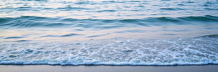 Obraz premium Gentle lapping of waves against the shore in a tranquil coastal setting with subtle color gradation, green, ocean, soothing