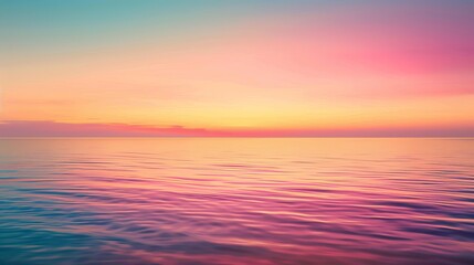Fototapeta premium A serene view of a tranquil ocean at sunset, showcasing pastel hues of pink, purple, and blue reflecting on the water's surface.