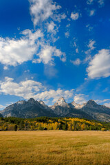 Grand Teton Mountains Tetons in Wyoming Rugged Mountain Range in Autumn Fall Landscape with blue sky and clouds