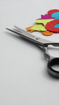 Group of colorful paper figures cut out with scissors