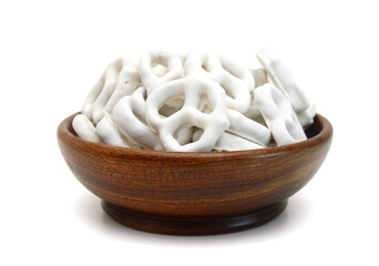 White chocolate covered pretzels on white background