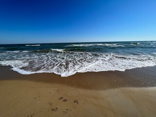 blue sky and beautiful tranquil sea at a lonely beach with golden sand