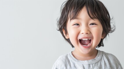 An Asian child with a toothy grin showcasing their prominent front teeth.