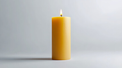 Tan candle mock-up standing upright, lit with a soft, warm flame.