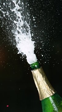 Super slow motion of Champagne explosion with flying cork closure, opening champagne bottle closeup. Filmed on high speed cinematic camera at 1000 frames per second.