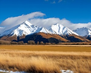 A mountain range with snow on the peaks and a clear blue sky