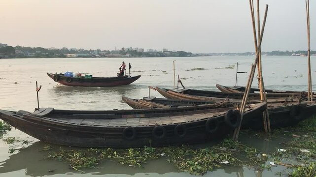 Serene Sunset running Boats Glide Along a Peaceful rupia River, Khulna in Bangladesh 