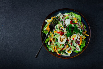 salad with squid, fresh cucumber, eggs, sweet pepper, red onion, with dressing, homemade, no people,