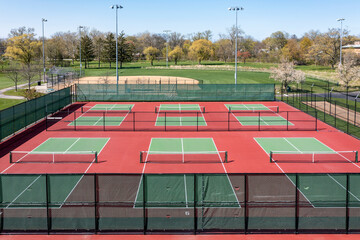 Aerial view of pickleball facility with red and green courts