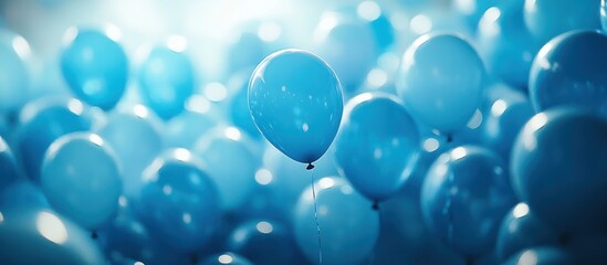 Fototapeta premium Close-up of a cluster of blue balloons, one in focus, the rest out of focus.