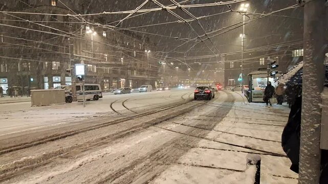 Heavy Evening Snowfall in Z&uuml;rich: Pedestrians and Public Transport Navigating Snow-Covered Streets