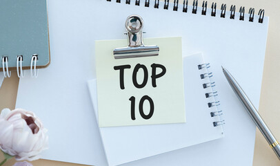 Top 10 written on paper sheet on wooden background