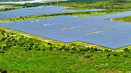 Aerial view of big sustainable electric power plant with many rows of solar photovoltaic panels for producing clean electrical energy. Renewable electricity with zero emission concept