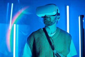 Man experiencing virtual reality with headset, standing in dimly lit room with electric blue neon...