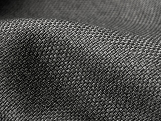 Macro photography of dark fabric, highlighting its texture and depth of color, creating an atmosphere of elegance and comfort