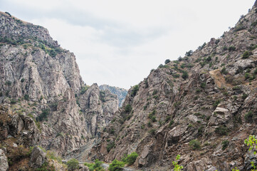 Rugged mountain landscape with steep cliffs and lush greenery