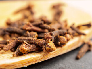 A close-up of aromatic cloves, highlighting the texture and rich color